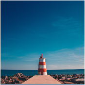 orange-and-white-lighthouse-on-dock-2096728